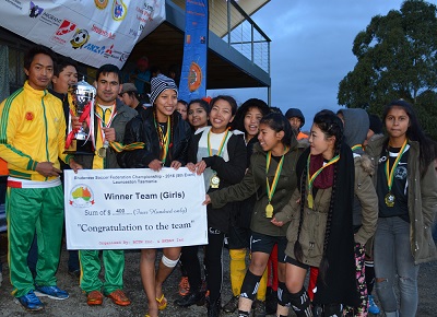 Bhutan soccer players with trophies and cheque certificate