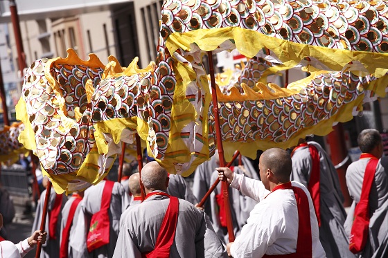 Chinese community carry a large dragon in a street parade
