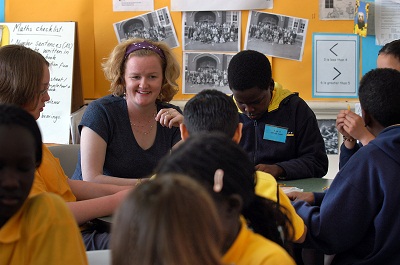 A teacher and students of different cultural background in a classroom.